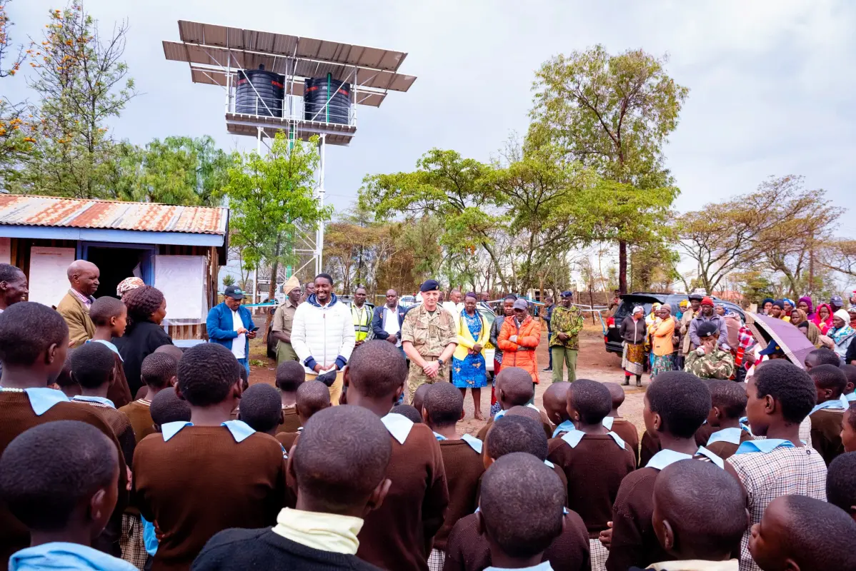 Community and school children gathered at a solar-powered water installation in Kenya